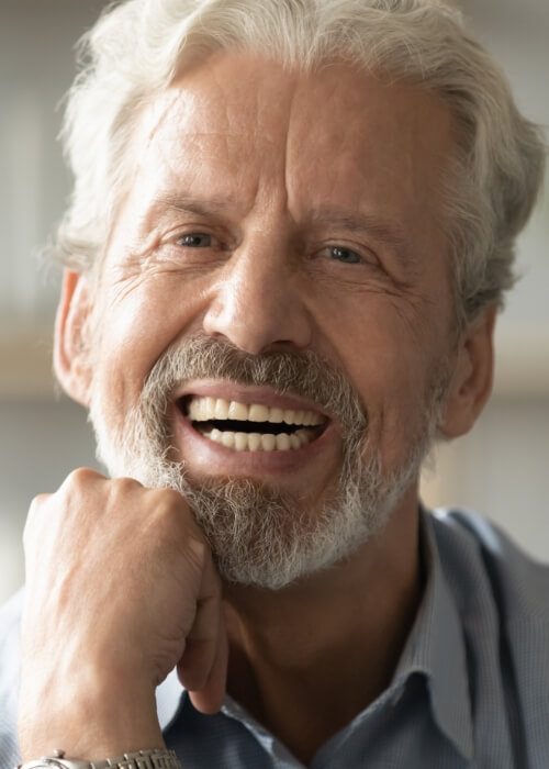 Senior man smiling with dentures in Cumming