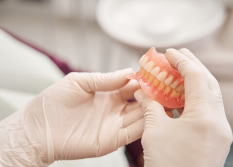 Dentist holding a set of full dentures