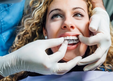 Dentist fitting a patient with a clear aligner