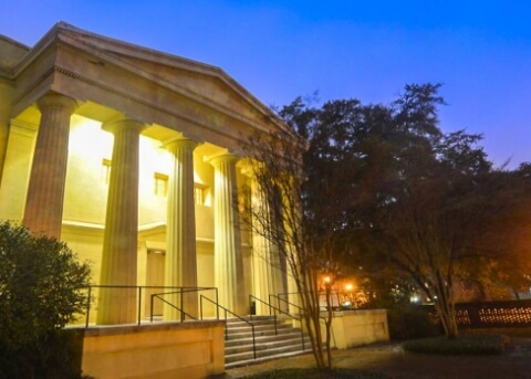 University building with white columns at night