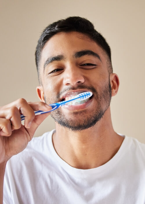 Man brushing his teeth for proper oral hygiene