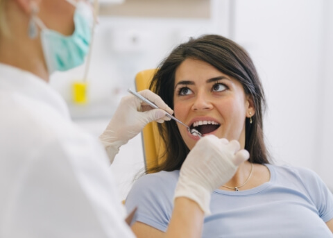 Woman having her mouth examined by her dentist