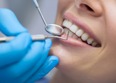 Close up of dentist performing a dental exam on a patient