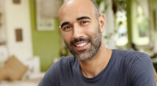 Smiling man in dark gray tee shirt
