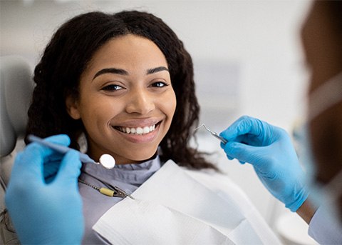 Woman smiling during dental exam