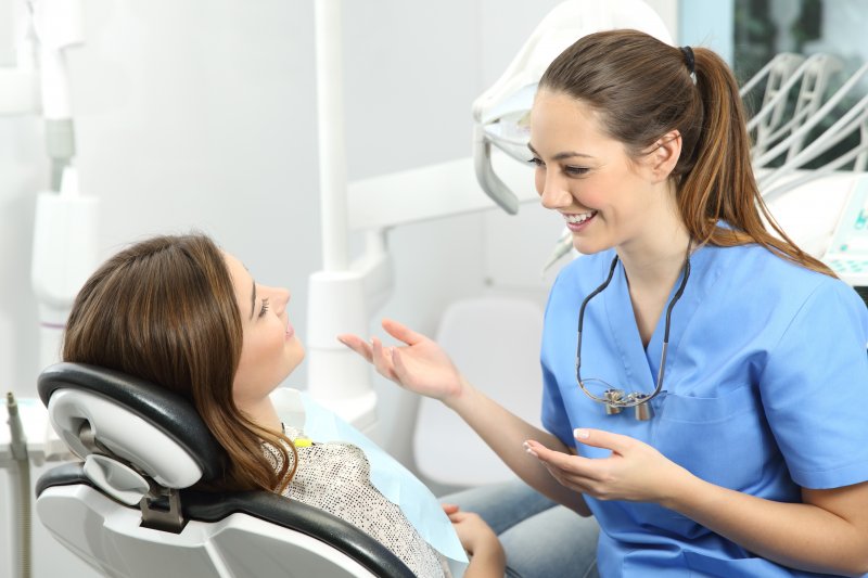 adult patient at dental appointment speaking to dentist 